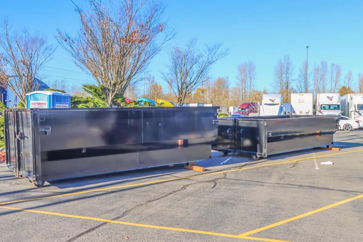 Professional dumpster rental service with roll-off container on residential driveway in Marlow Heights